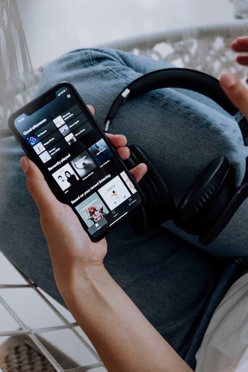 Person holding phone and headphones